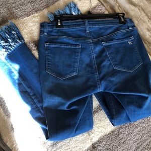 Blue Jessica Simpson jeans with fringed bottoms
